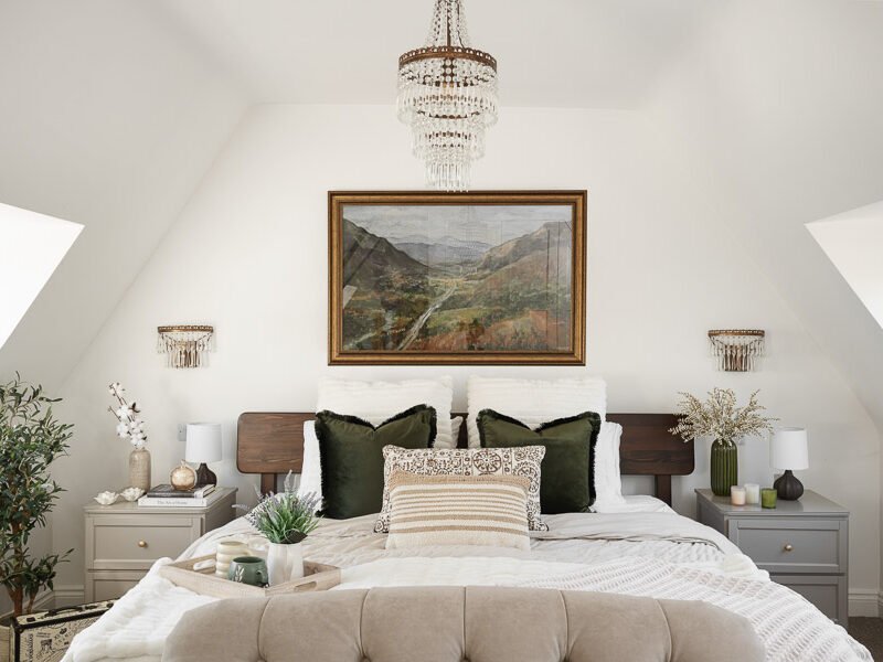 Elegant attic conversion in the Cotswolds featuring exposed beams, soft layered textures, and natural light—interior design by a Cotswolds-based designer.